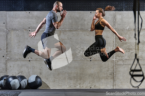 Image of A fit couple exercising various types of jumps in a modern gym, demonstrating their physical fitness, strength, and athletic performance