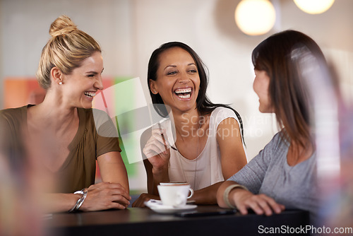 Image of Once she got them laughing they couldnt stop. three women enjoying a conversation in a restaurant.