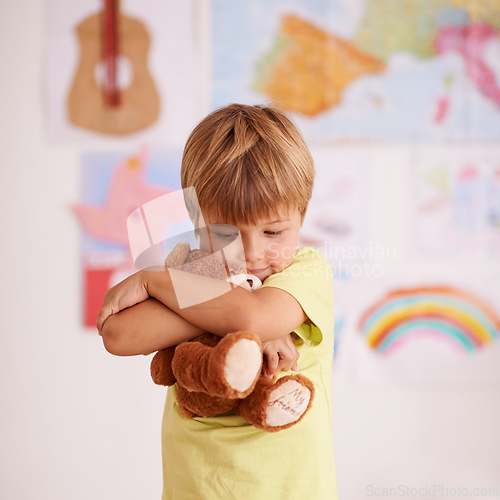 Image of Theres no comfort quite like a favorite teddy. a cute little boy hugging his teddybear.