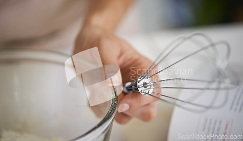 Image of Where the action happens. Closeup shot of a woman using baking utensils in a kitchen.