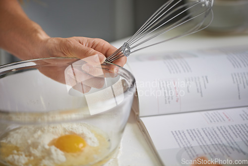 Image of Whisking in a bit of goodness. Closeup shot of a woman making dough in her kitchen.