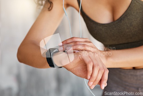 Image of How many calories did I burn. an unrecognisable woman using her watch during her outdoor workout in the city.