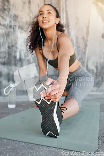 Image of There will be no sore legs today. a young woman stretching before her outdoor workout in the city.