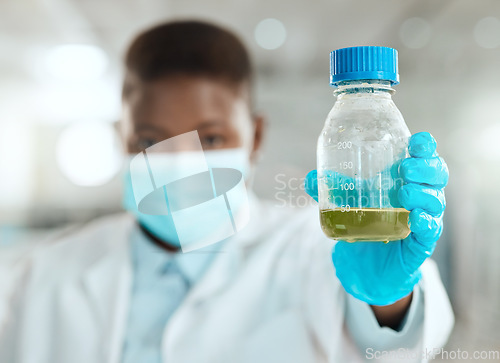 Image of Im testing this today. an unrecognisable scientist holding a bottle of liquid for testing in her laboratory.