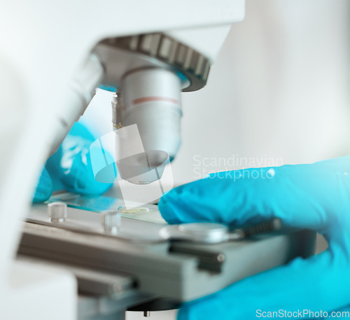 Image of Time to take a closer look. an unrecognisable scientist using a microscope to analyse a sample in the laboratory.