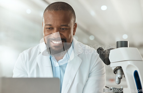 Image of Thats all the tests done. a handsome mature scientist sitting alone in his laboratory and using his laptop.