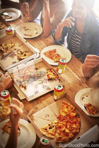 Image of All you can eat. a group of friends enjoying pizza together.