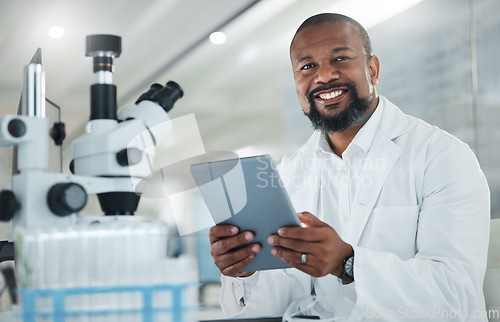 Image of I just cant make a breakthrough with this case. a male scientist using a digital tablet while working in a lab.