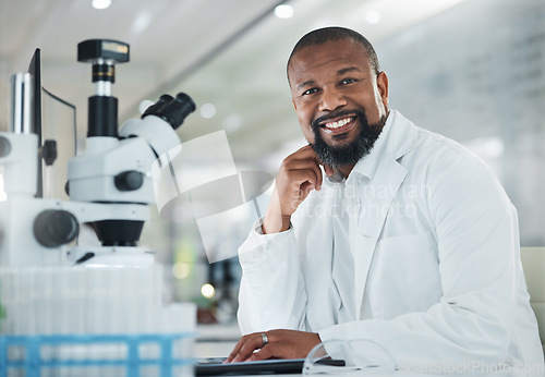 Image of Sharing viewpoints on the days discoveries. a mature man using a microscope in a lab.