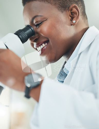 Image of Making informed decisions based off his thorough research. a young woman using a microscope in a lab.