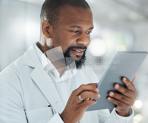 Image of My work will contribute to an amazing body of research. a male scientist using a digital tablet while working in a lab.