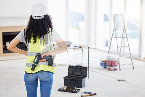 Image of Where am I placing these nails. an unrecognisable contractor standing alone and holding a power drill in a room during the day.