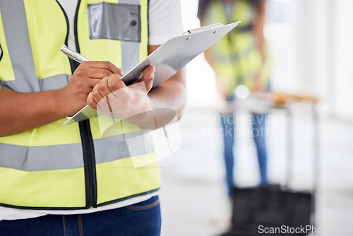 Image of Weve got all our supplies right here. an unrecognisable contractor standing inside and using a clipboard.