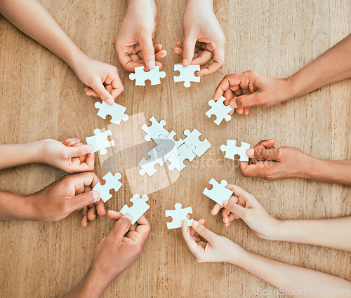 Image of Completing each other. a family building a puzzle together at home.