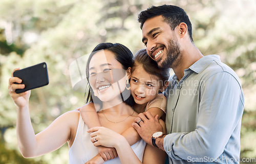 Image of My loves, the light of my life. a happy young family taking selfies in a garden.