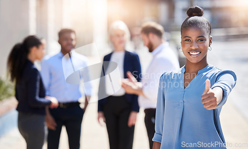 Image of Start every day with a positive thought. a young businesswoman showing a thumbs up outside.