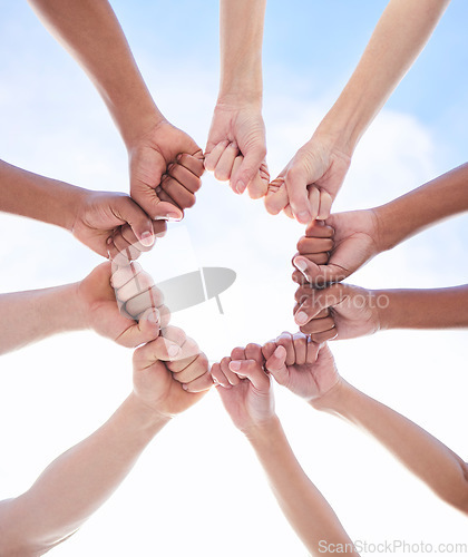 Image of We can achieve it if we do it together. a group of unrecognizable people making a circle with their fists outside.