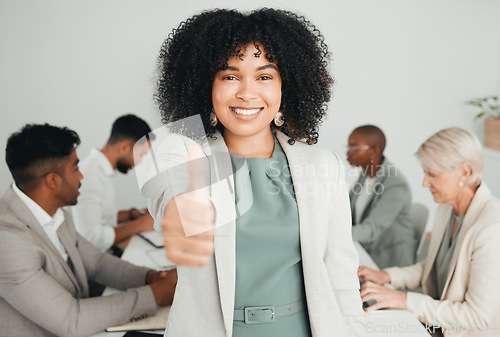 Image of Good things come from teamwork. a young businesswoman showing a thumbs up at work.