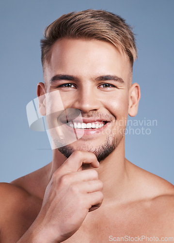 Image of I have a little beard going on here. Closeup shot of a handsome young man smiling while posing against a studio background.
