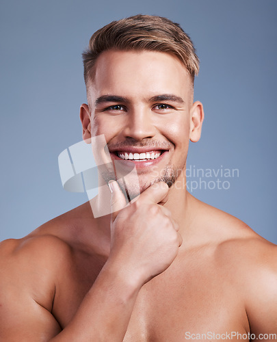 Image of Ive decided to grow my beard. Closeup shot of a handsome young man smiling while posing against a studio background.