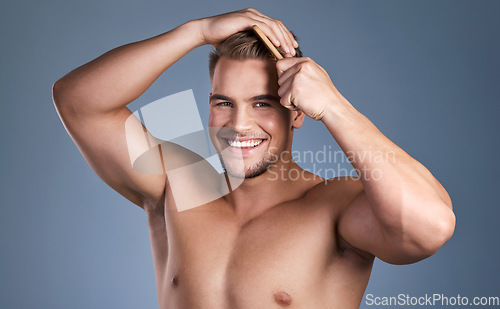 Image of Go take care of yourselves. a handsome young man combing his hair.