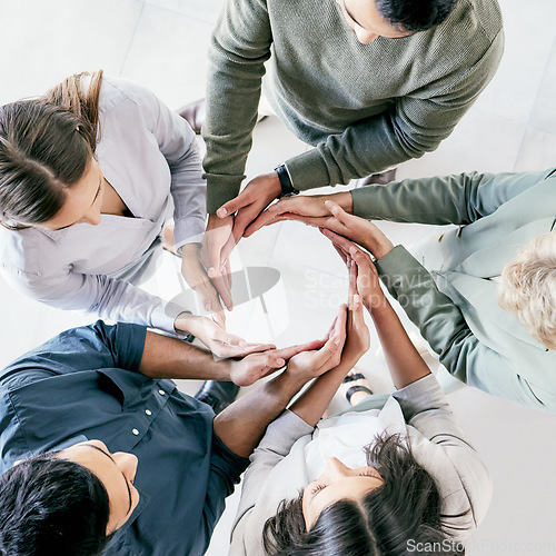 Image of Do the hard jobs first. High angle shot of a group of unrecognizable businesspeople forming a circle with their hands at work.