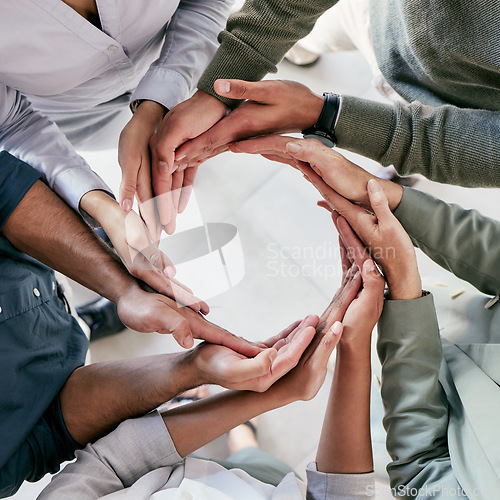 Image of Success is the doing, not the getting. High angle shot of a group of unrecognizable businesspeople forming a circle with their hands at work.