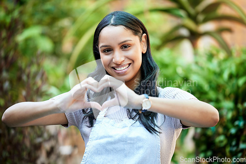 Image of Its always Saturday in this store. a female business owner forming a heart with her fingers in her nursery.