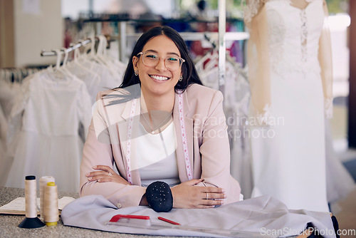 Image of Her designs will leave you in awe. an attractive young seamstress working in a bridal boutique.