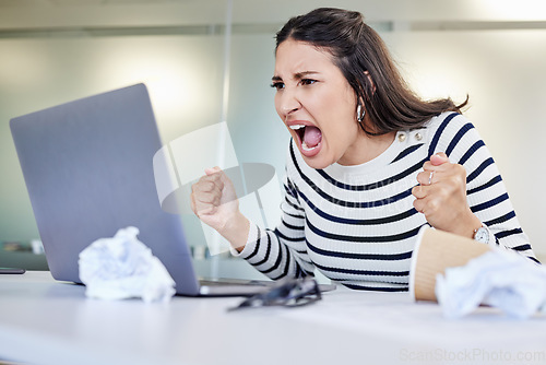 Image of Its probably time to take a break. a young businesswoman looking angry while using a laptop in an office at work.