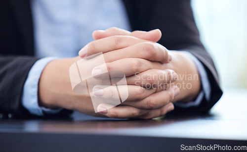 Image of The easy jobs will take care of themselves. an unrecognisable businesswoman sitting alone in his office with his hands clasped.