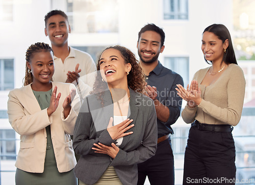 Image of I feel so special. a group of businesspeople clapping for a colleague at work.