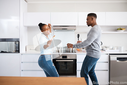 Image of Nothing but good vibes. a young couple dancing at home.