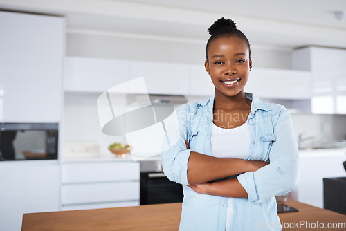 Image of Im the lady of the house. a young woman standing with her arms crossed at home.