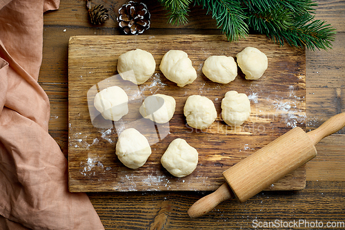 Image of dough balls on wooden cutting board