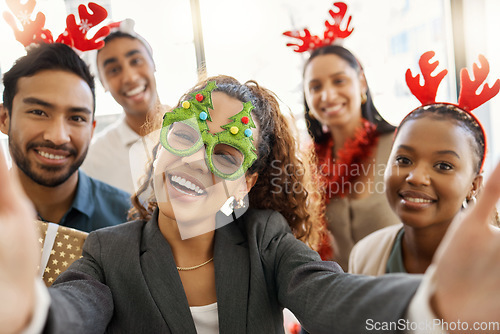 Image of Its party time. a group of businesspeople taking a selfie during a Christmas party at work.
