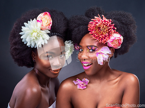 Image of Let me introduce you to blossom and bloom. two beautiful women posing together with flowers in their hair.