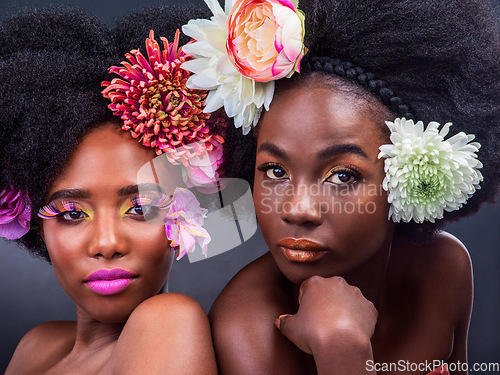 Image of Flowers dont tell, they show. two beautiful women posing together with flowers in their hair.
