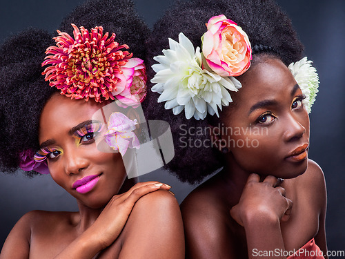 Image of Who said anything about plain. two beautiful women posing together with flowers in their hair.