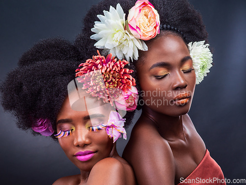 Image of Dont just live, bloom. two beautiful women posing together with flowers in their hair.