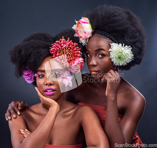 Image of Flourishing in floral. two beautiful women posing together with flowers in their hair.