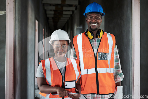 Image of The harder we work the happier our clients are. a young man and woman using a digital tablet while working at a construction site.