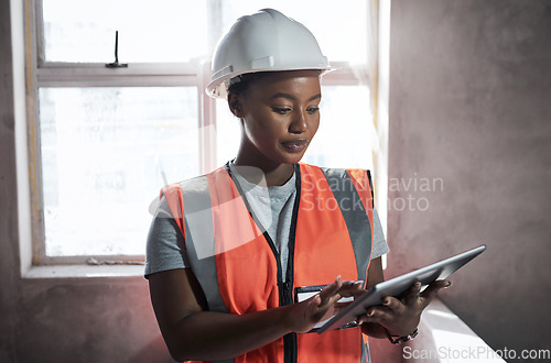 Image of Safety inspection is first on the agenda. a young woman using a digital tablet while working at a construction site.