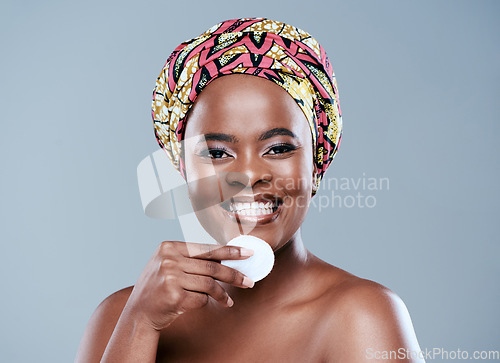 Image of Im enhancing what nature gave me. Studio portrait of a beautiful young woman posing with a jar of face lotion against a grey background.