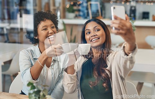 Image of We always caffeine our way back to each other. two friends taking a selfie while sitting together in a coffee shop.