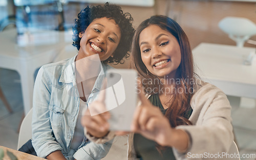 Image of Some connections are stronger than others. two friends taking a selfie while sitting together in a coffee shop.