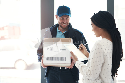Image of Great service that will leave every customer satisfied. a handsome delivery man getting a signature from a female customer for her order.