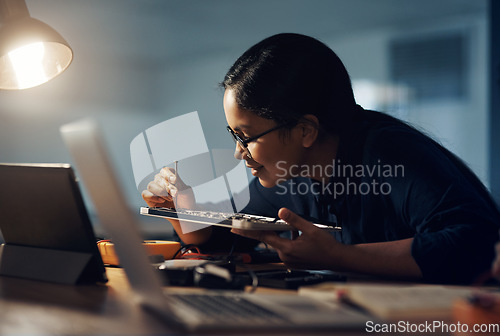 Image of She doesn’t give up until it gets fixed. a young technician using a screwdriver to repair computer hardware.