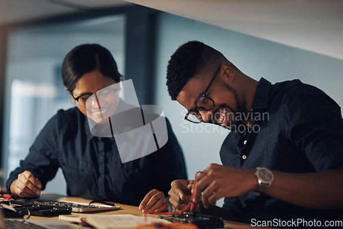 Image of Have no fear, the tech experts are here. two young technicians repairing computer hardware together.