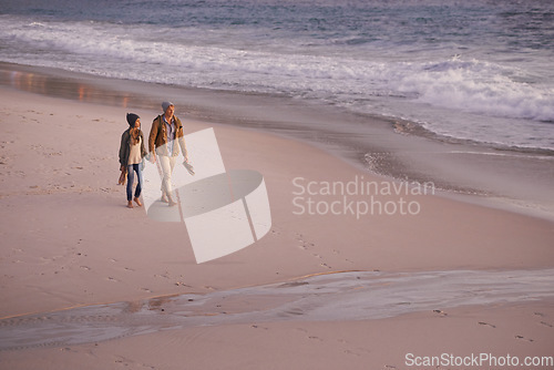 Image of Everytime were together I fall in love all over again. a young couple enjoying a romantic stroll on the beach.